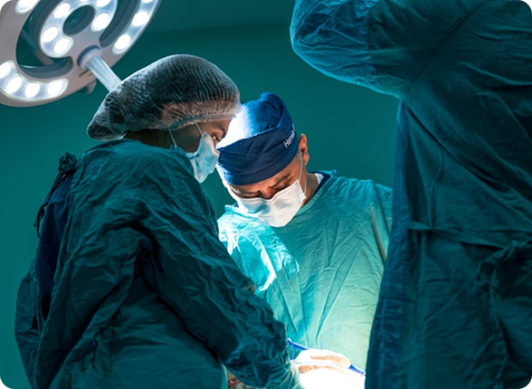 A team of surgeons performing an operation under surgical lights