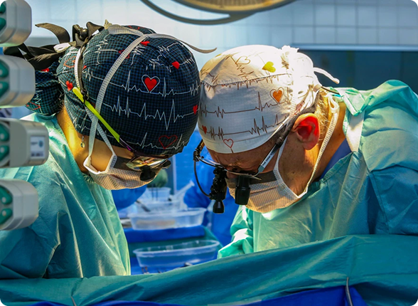 A team of surgeons performing an operation under surgical lights