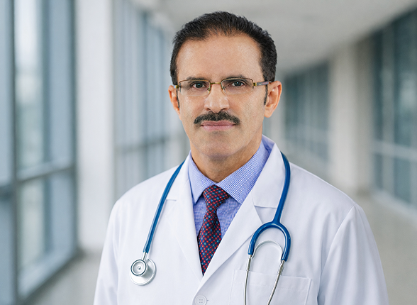 A team of surgeons performing an operation under surgical lights